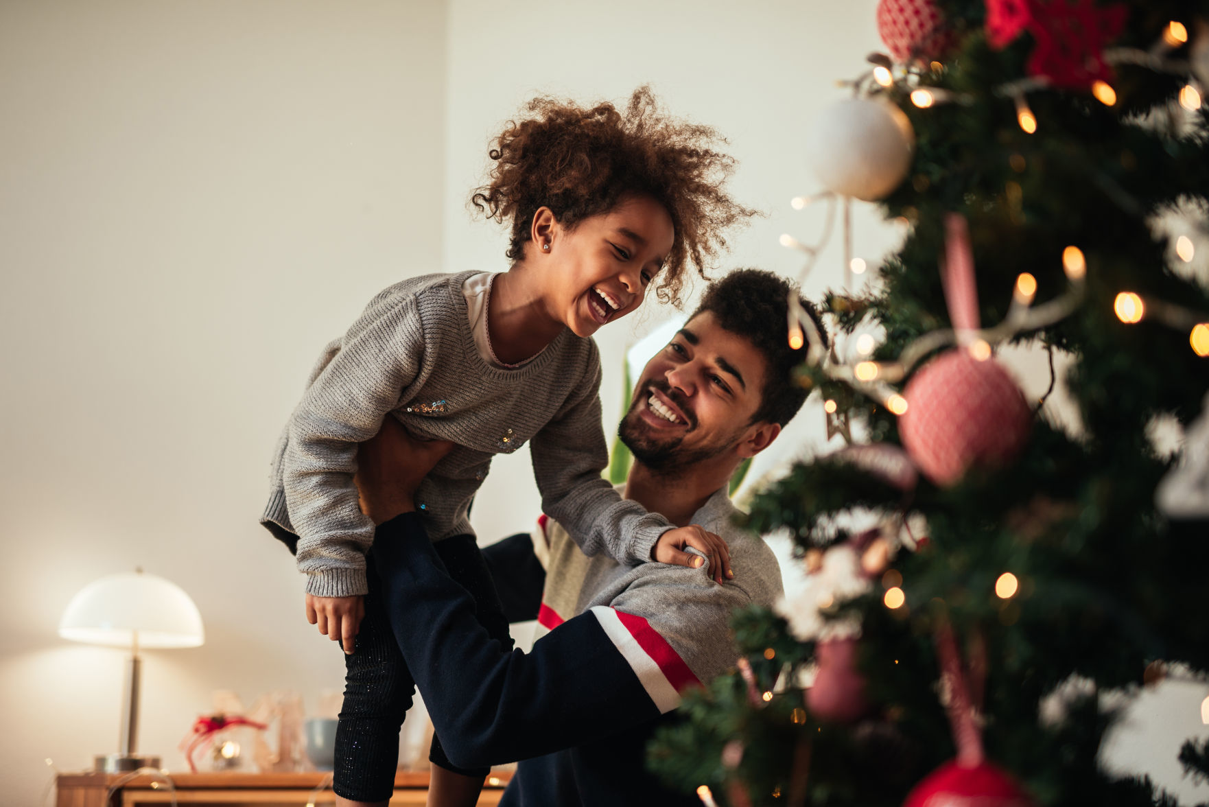 Reaching for the top of the Christmas tree!